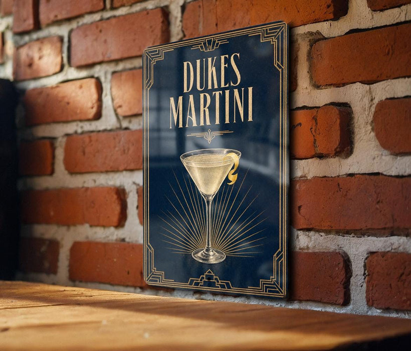 A sign for Dukes Martini is displayed on a brick wall, featuring an illustration of a martini glass.