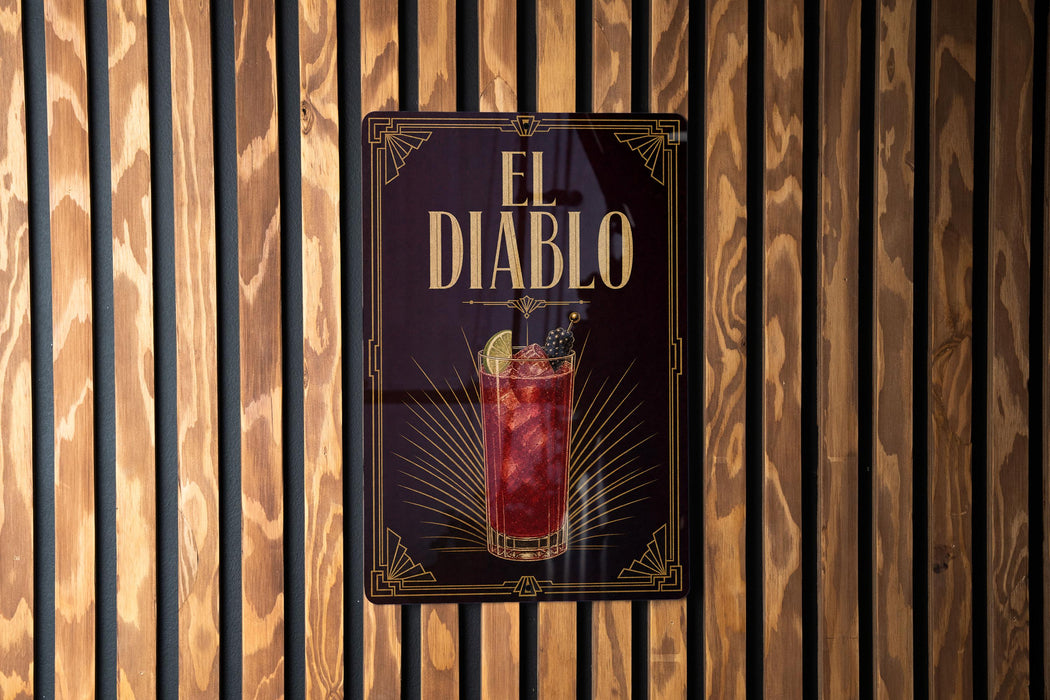 a sign for "El Diablo", which is a cocktail, hanging on a wooden wall.