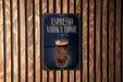 A sign for an espresso vodka tonic cocktail, featuring an illustration of a glass filled with the drink and ice cubes.