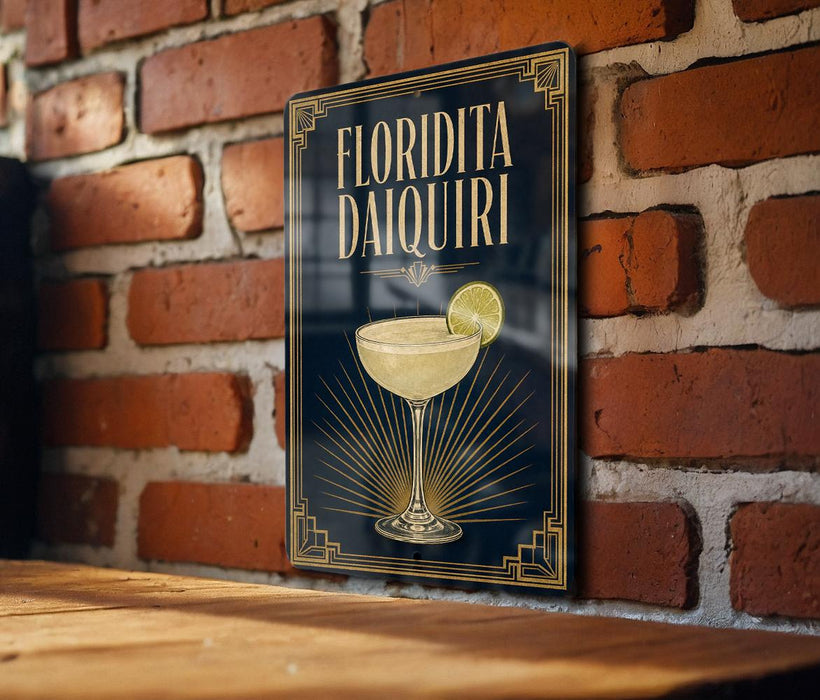 A framed poster of a cocktail called "Florida Daiquiri" is displayed on a brick wall.