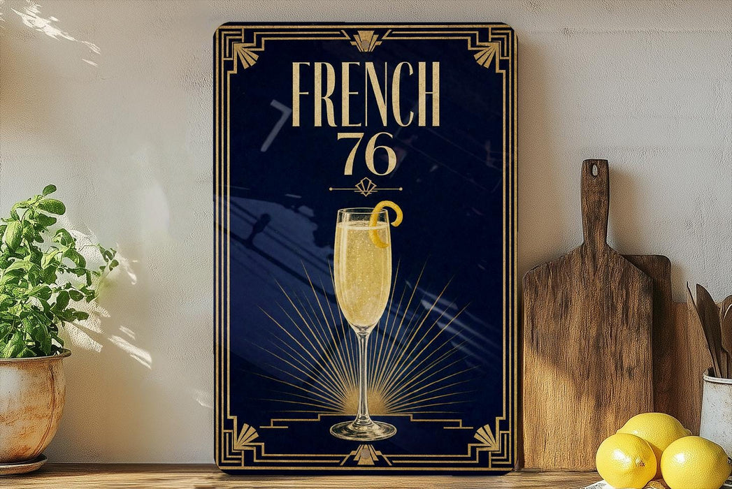 a framed poster with a champagne glass and lemon on a dark blue background, along with a wooden cutting board and some lemons.