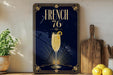 a framed poster with a champagne glass and lemon on a dark blue background, along with a wooden cutting board and some lemons.