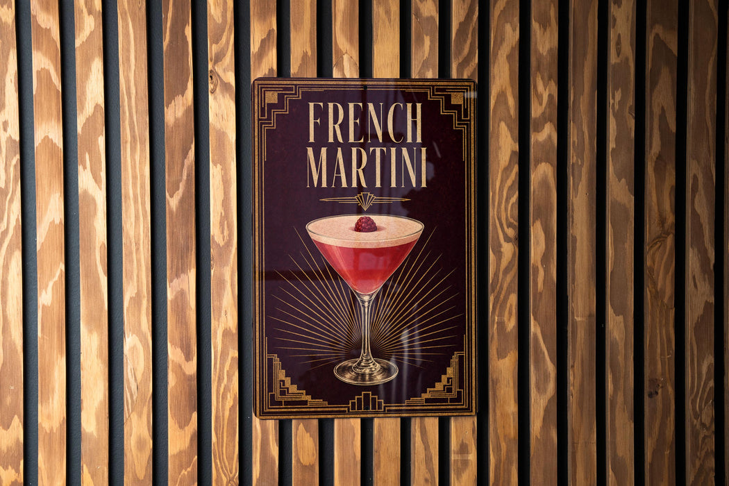 A poster advertising a French Martini is displayed on a wooden wall.