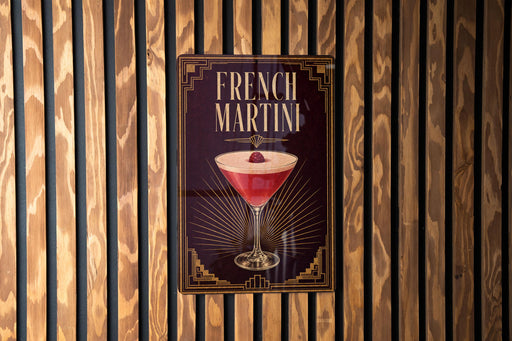 A poster advertising a French Martini is displayed on a wooden wall.