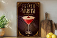 a decorative sign for a French martini, with a glass of the cocktail prominently displayed.