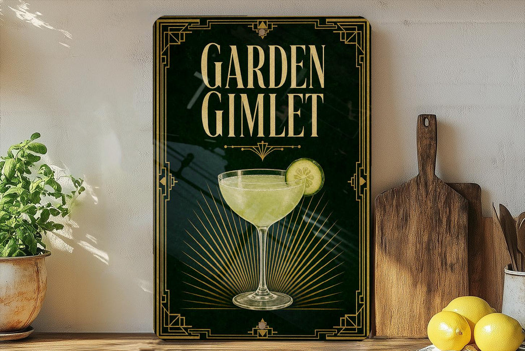 A framed advertisement for a "Garden Gimlet" cocktail, featuring a glass of the drink with a slice of lemon, is displayed on a shelf next to a wooden cutting board and a potted plant.