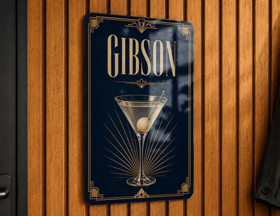 A sign with the word "GIBSON" on it, featuring an illustration of a martini glass with a lime wedge.