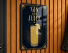A sign with the text "GIN AND JUICE" and an illustration of a cocktail glass with a lemon slice.