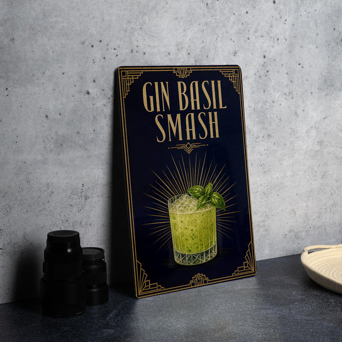 A framed poster advertising a Gin Basil Smash cocktail, featuring an illustration of a cocktail glass with a sprig of basil.