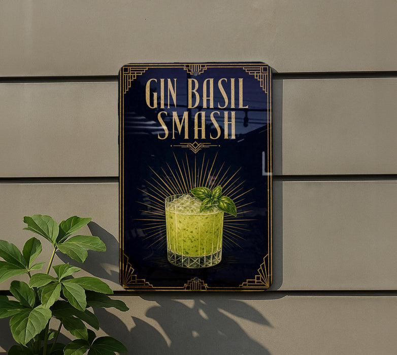 A sign for a gin smash cocktail, featuring a glass of the drink with a sprig of basil on top, against a dark background with decorative elements.
