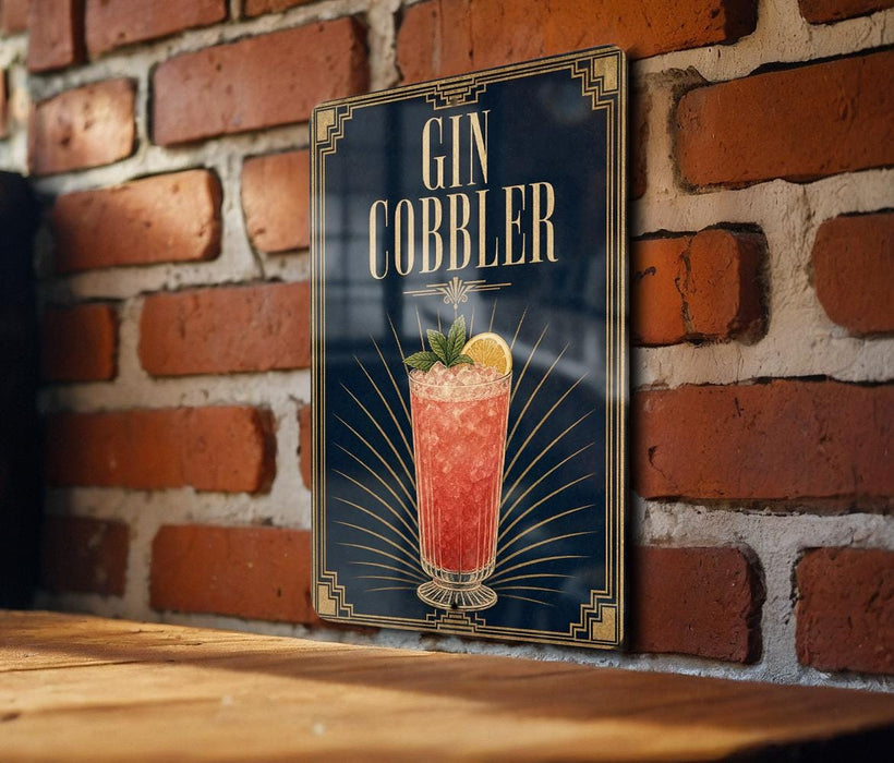 A sign for a gin cobler cocktail is displayed on a brick wall.