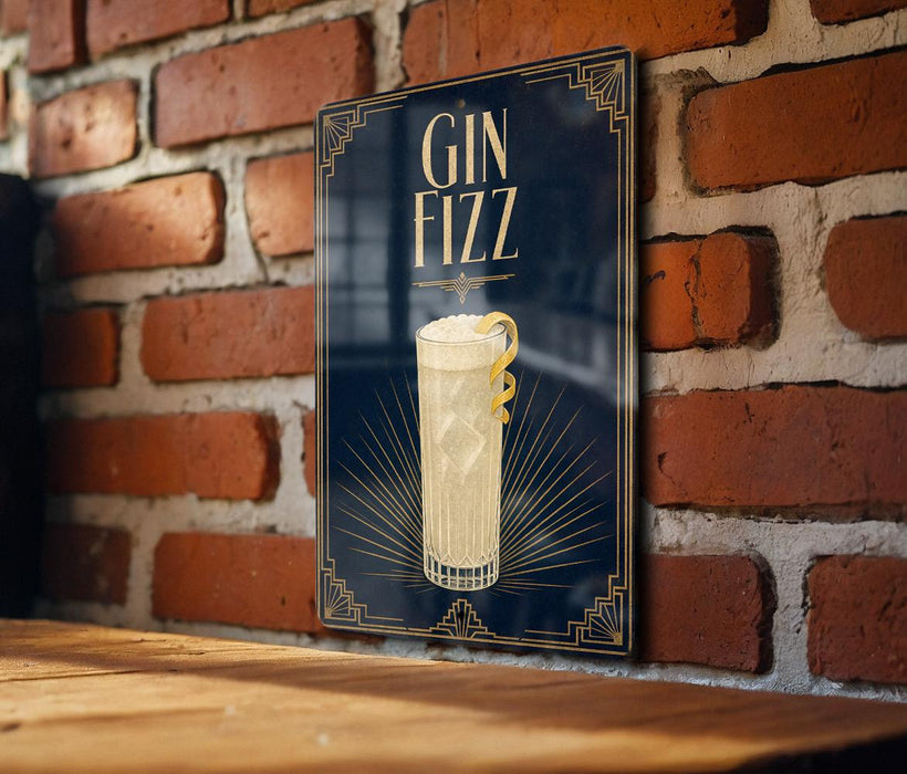 A sign with the text "GIN Fizz" and an illustration of a cocktail glass with a lemon twist, mounted on a brick wall.