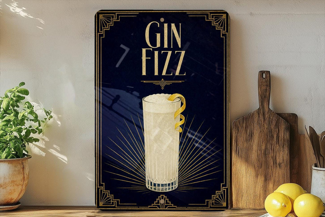 A decorative sign with the text "GIN Fizz" and an illustration of a cocktail glass with a lemon twist, placed on a wooden surface next to a potted plant and a cutting board.