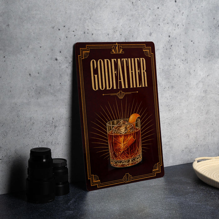 A decorative sign with the word "GODFATHER" and an illustration of a cocktail on a dark background.