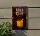 a sign with the text "GOLD RUSH" and an illustration of a cocktail glass with a lemon slice.