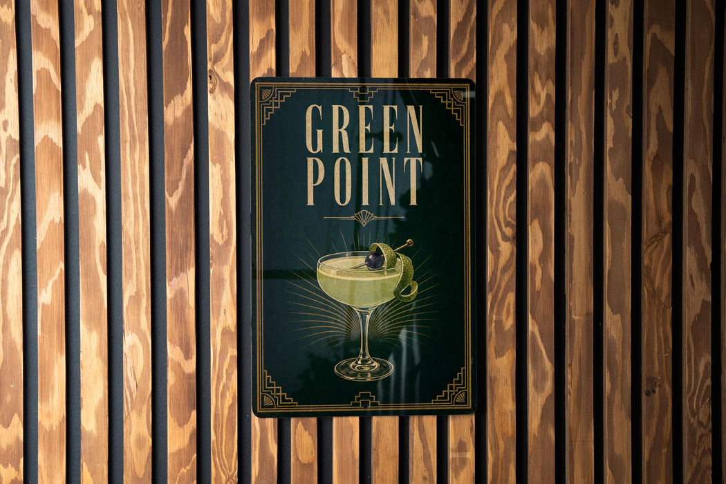 A sign for "Green Point" cocktail is displayed on a wooden wall.