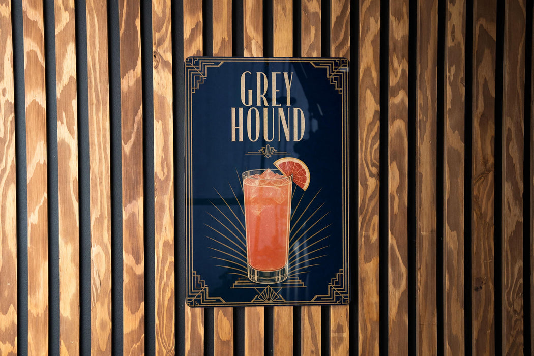 A poster advertising a drink called "Greyhound" is displayed on a wooden wall.
