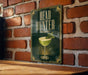 a sign with the text "HEAD HUNTER" and an illustration of a cocktail glass with a mint leaf.