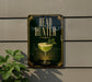 a sign that reads "HEAD HUNTER" with a picture of a green drink in a glass and a leaf on top.