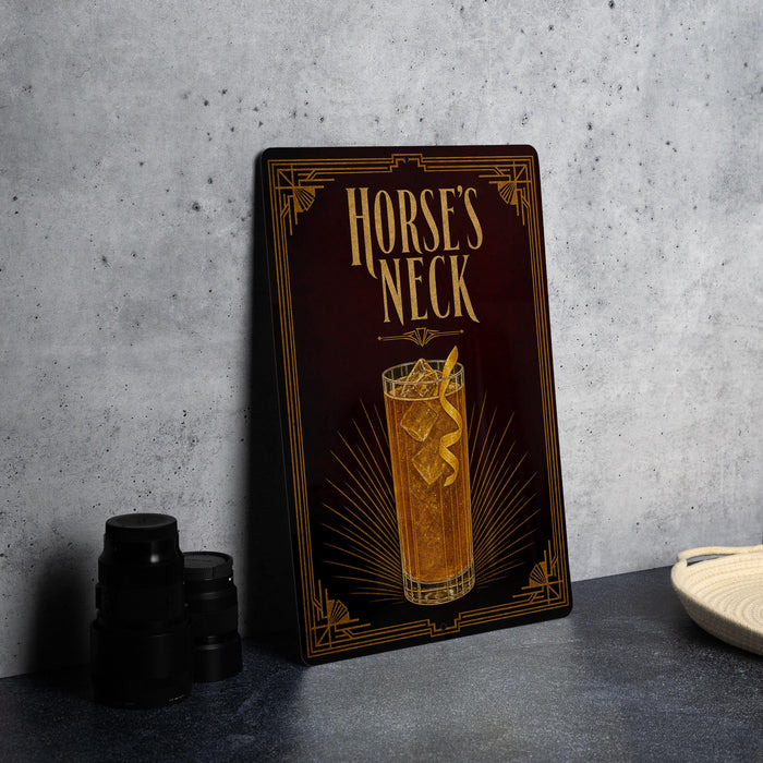 a framed illustration of a cocktail glass with a lemon twist, accompanied by the text "HORSE'S NECK" on a dark background.