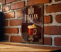 A sign with the text "HOT ITALAN" and an illustration of a hot beverage, likely a cocktail or hot drink, against a brick wall background.