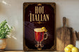 A framed poster advertising "Hot Italian" cocktail, featuring an illustration of a red cocktail with a lemon twist.