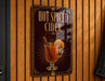 A sign advertising "Hot Spiced Cider" is displayed on a wooden wall.