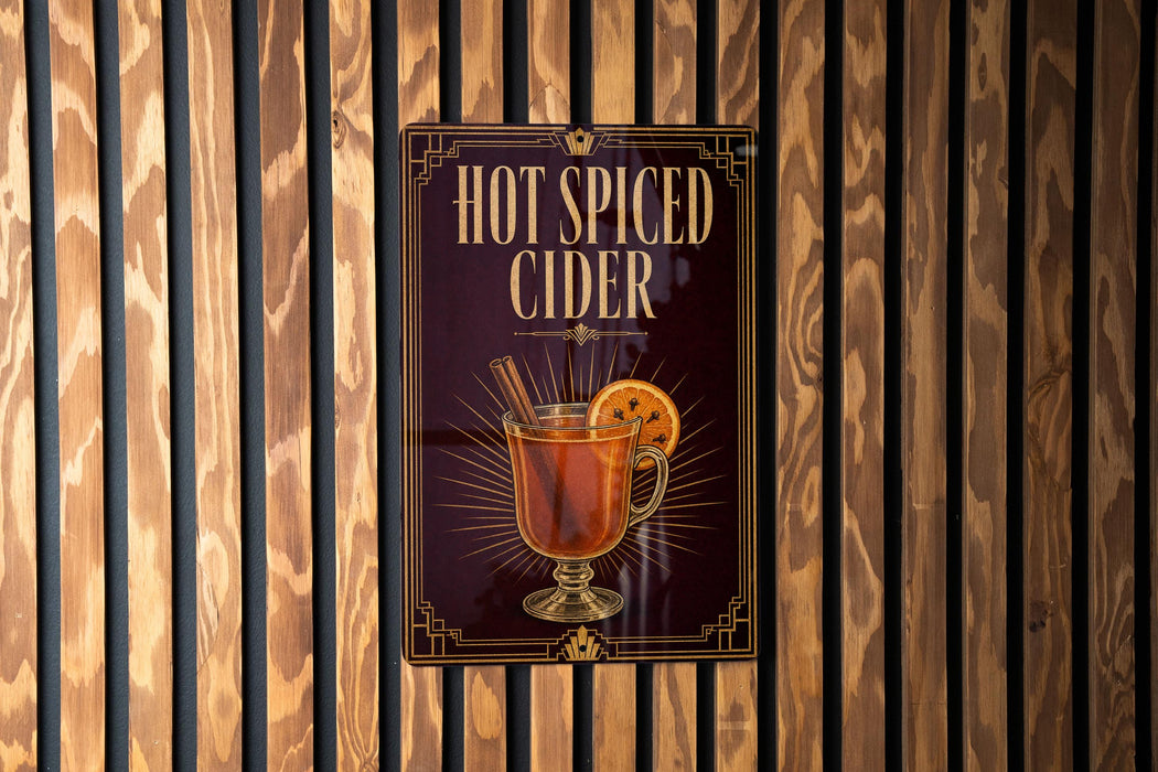 A sign for "Hot Spiced Cider" is displayed on a wooden wall.