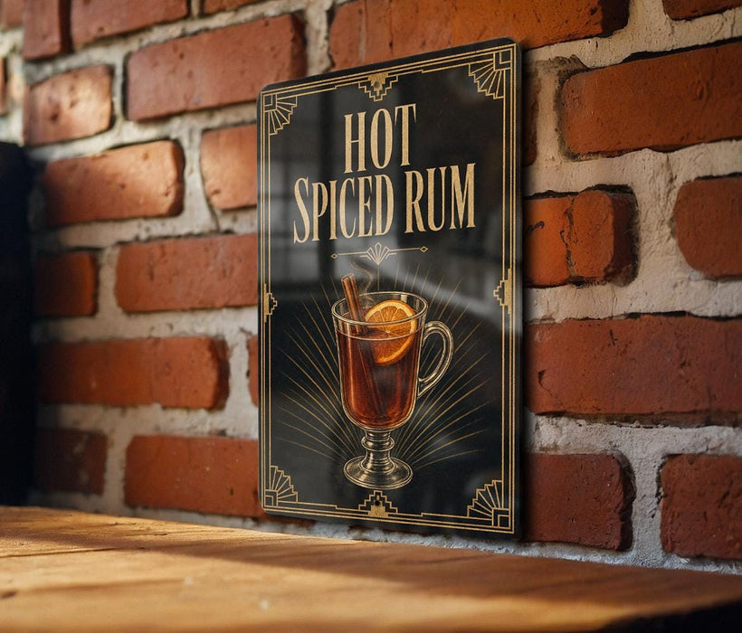 A sign with the text "HOT SPICED RUM" and an illustration of a glass of hot spiced rum with a slice of lemon and a cinnamon stick.