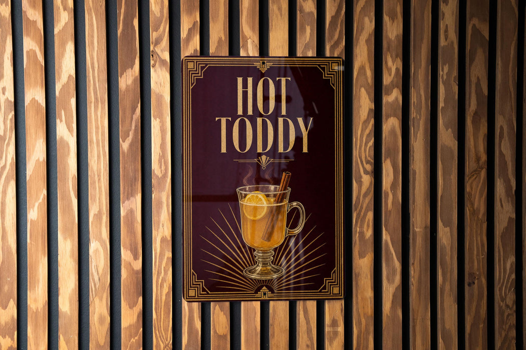 A sign for "Hot Toddy" is displayed on a wooden wall.