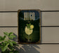 A sign for a bar called "HUGO" with a glass of a yellow drink and a lemon slice, set against a green background with a decorative border.