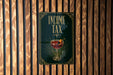 a poster with the text "INCOME TAX" and an illustration of a martini glass with an orange twist.