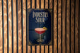 A poster with the title "INDUSTRY SOUR" displayed prominently, featuring an illustration of a cocktail glass with a lemon twist.