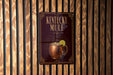 A sign for "Kentucky Mule" is displayed on a wooden wall, featuring an illustration of a copper mug with a lemon slice.