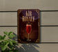 a sign for "Kir Royale" cocktail, which is a red drink with a garnish, displayed on a wall.