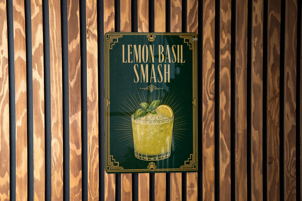 A sign for a lemon basil smash cocktail is displayed on a wooden wall.