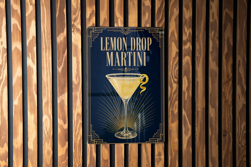 A sign for a lemon drop martini is displayed on a wooden wall.