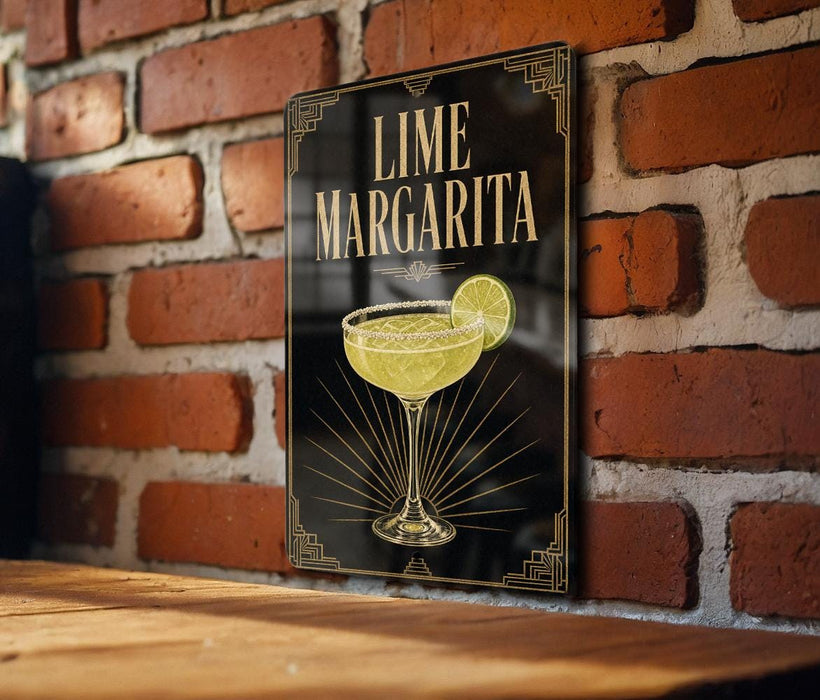 A framed poster of a lime margarita on a brick wall, featuring a stylized illustration of a margarita glass with a lime slice.