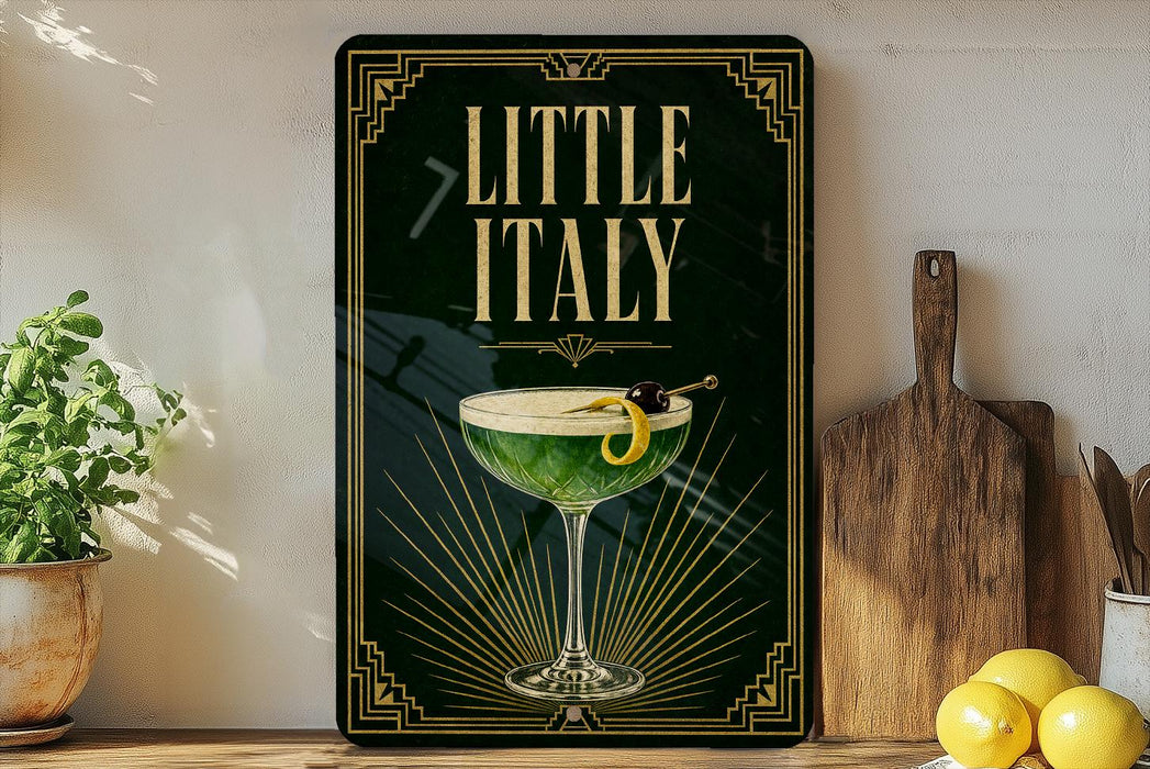 a framed poster with a green cocktail glass and a lemon twist, placed on a shelf next to a wooden cutting board and a potted plant.