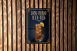 A poster advertising Long Island Iced Tea, featuring a tall glass filled with iced tea and a lemon slice.