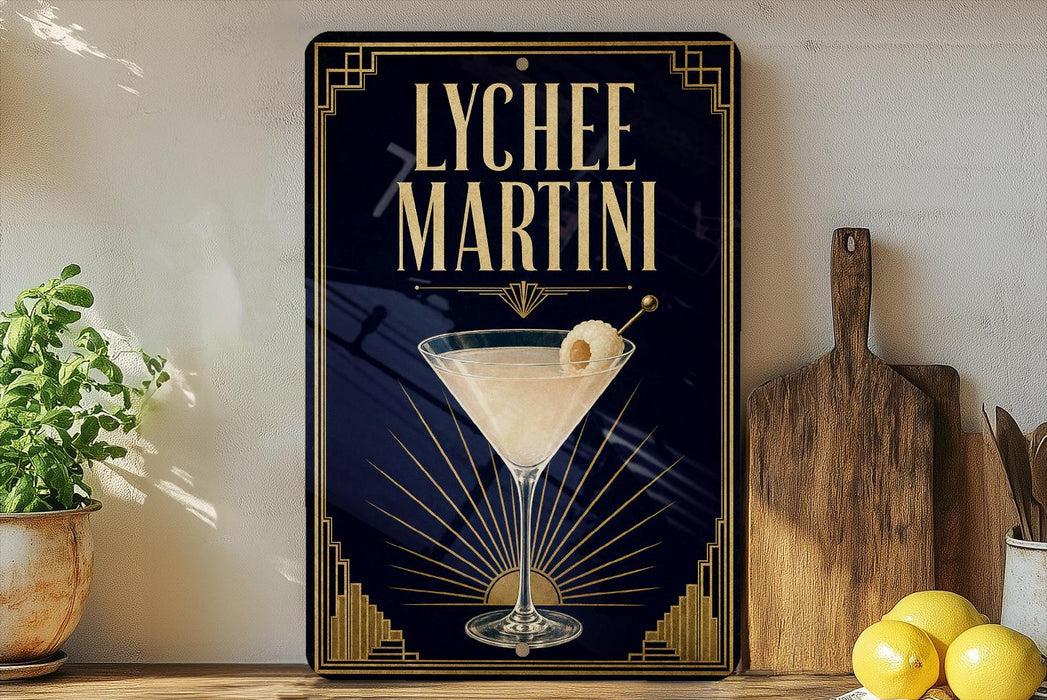 A framed advertisement for Lychee Martini, featuring a martini glass with a lemon twist on a dark background with a sunburst design.
