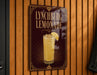 A sign for "L Lynchburg Lemonade" is displayed on a wooden wall.