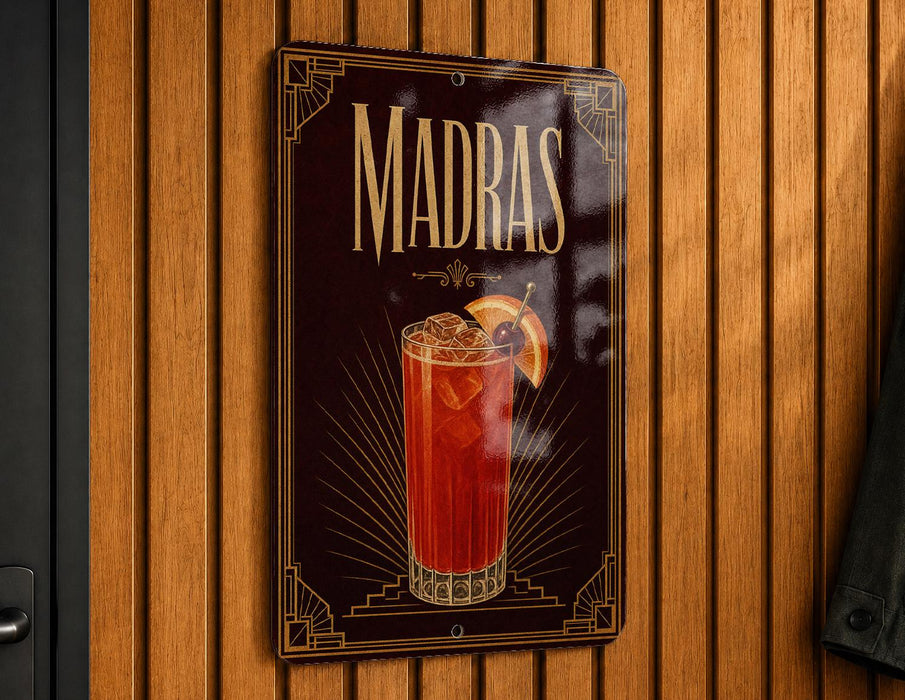A decorative sign for Madras cocktails hangs on a wooden wall.