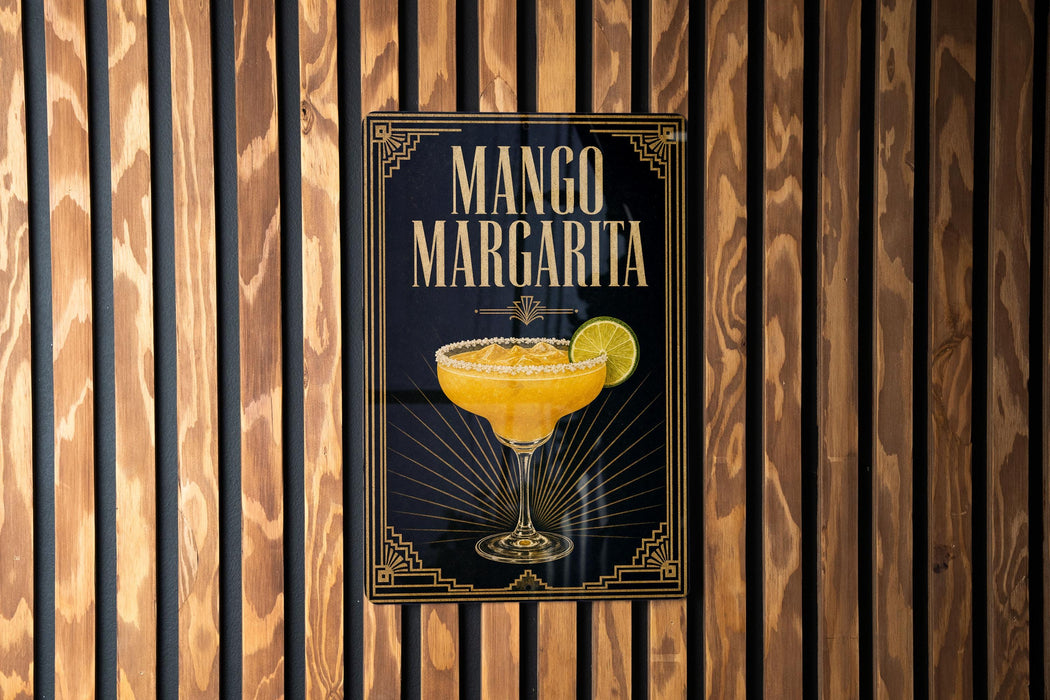 A poster for a mango margarita cocktail is displayed on a wooden wall.