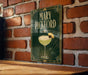 A decorative sign featuring the name "Mary Pickford" and an illustration of a cocktail glass with a lemon twist.