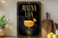 a framed advertisement for a drink called "Mauna Loa", which is a cocktail. The advertisement displays a glass of the drink with a pineapple garnish and a cherry, along with the text "MAUNA LOA" prominently displayed.