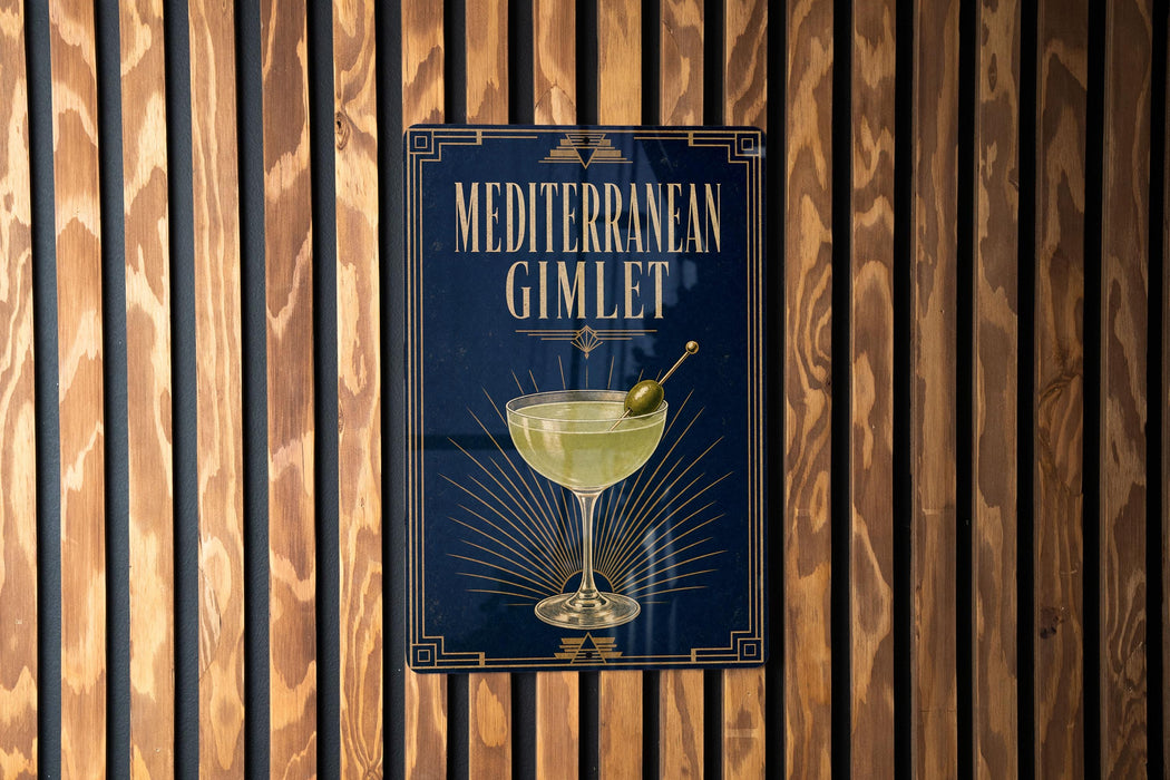 a sign for a Mediterranean cocktail called the Mediterranean Gimlet, which is displayed on a wooden wall.
