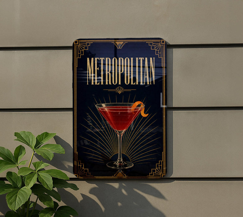 A decorative sign for "Metropolitan" cocktail, featuring a martini glass with a garnish, is displayed on a wall.