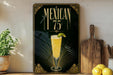 A decorative sign with the text "MEXICAN 75" and an illustration of a glass of Mexican beer with a lime on a wooden surface.