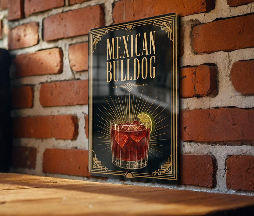 A decorative sign with the text "MEXICAN BULLDOG" and an illustration of a glass of tequila with a lime on a brick wall.